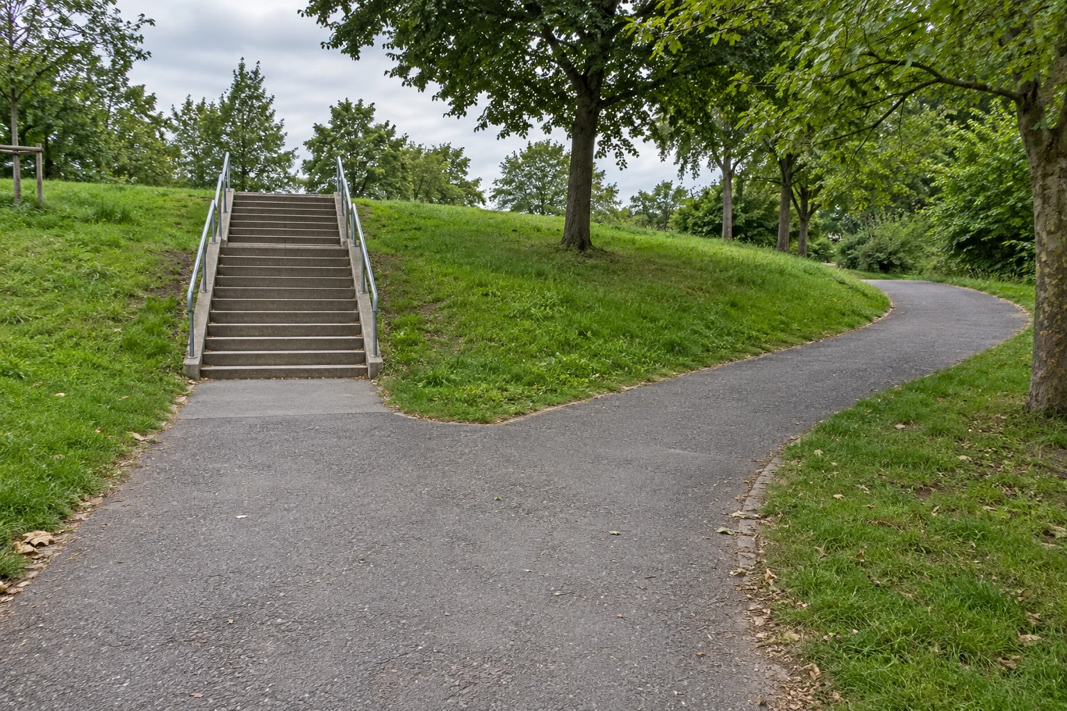 Park path branching beside an outdoor stairway